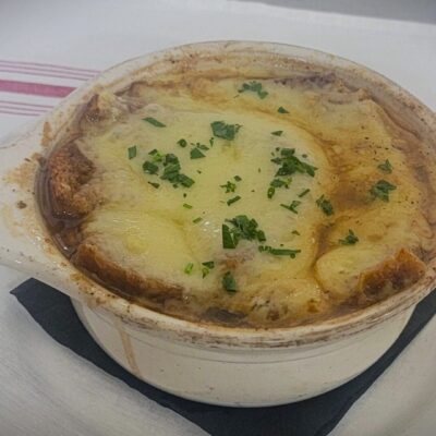 A bowl of soup, perfect for recipes or a quick meal, is sitting on top of a plate.