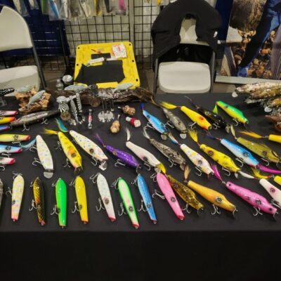Colorful handcrafted fishing lures displayed.