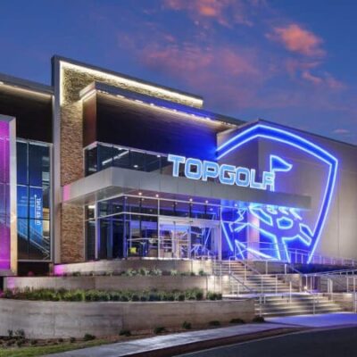 The exterior of a building with a blue and purple light.