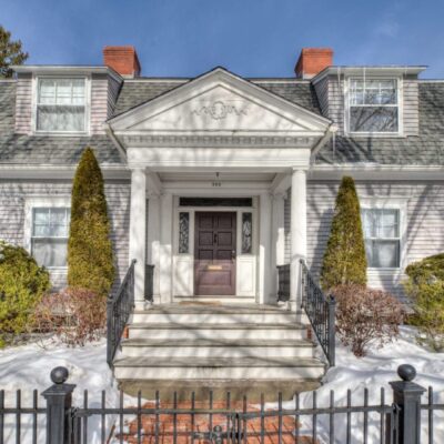 Elegant historic mansion with a grand entrance and symmetrical design.