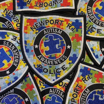 A pile of patches with the word autism on them.