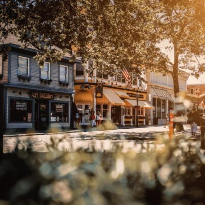 A street scene with buildings and trees in the background.