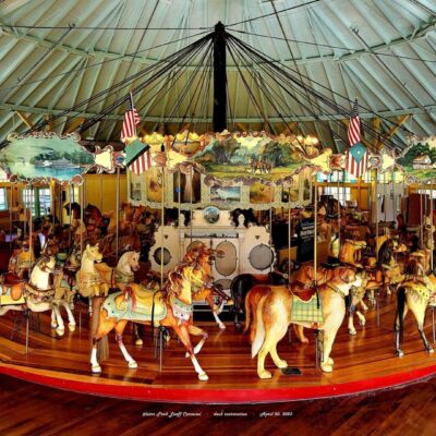 A carousel with many horses.