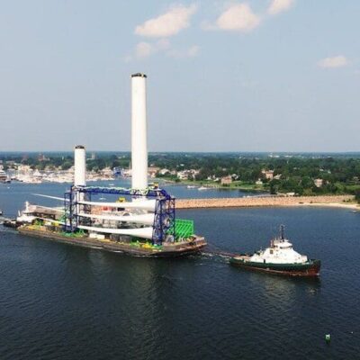 An aerial view of a Vineyard Wind turbine in a body of water.