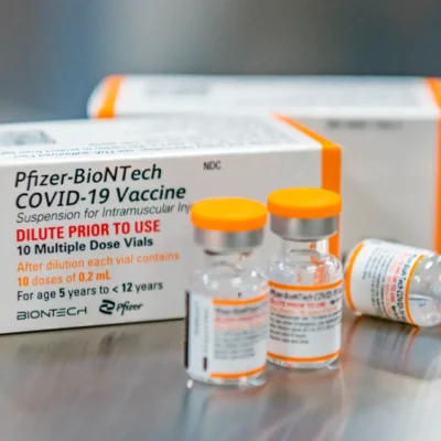 A box of covid vaccines sits on a table.