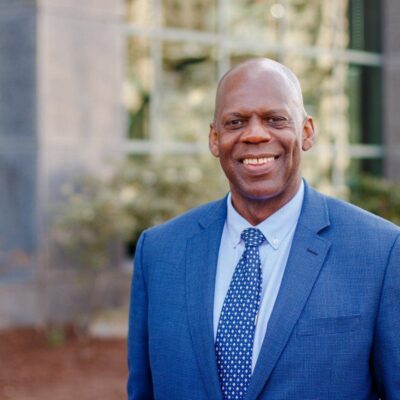 An african-american man in a blue suit and tie.