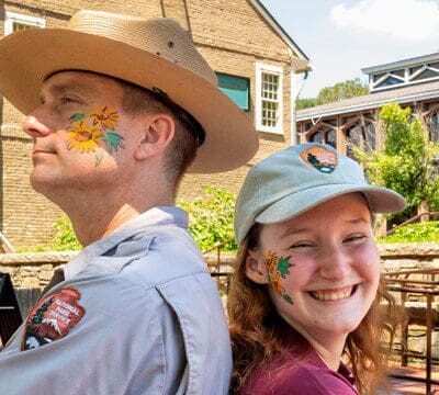 A man and a woman with providence painted on their faces.