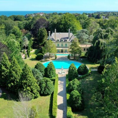 Oceanfront mansion with pool and gardens.