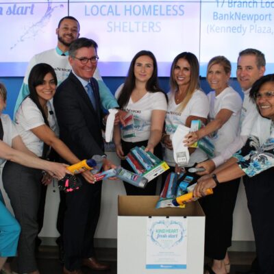 A group of people standing in front of a box.