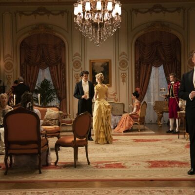 A group of people in formal attire in a room.