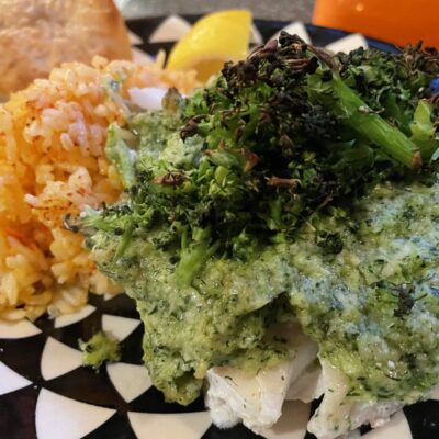 A plate with broccoli, rice and a pastry.