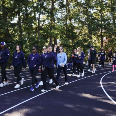 Group walking on a track outdoors.