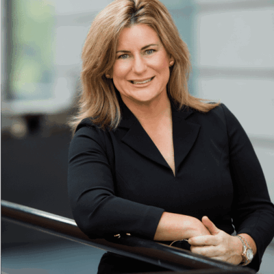 Smiling businesswoman in black blazer.