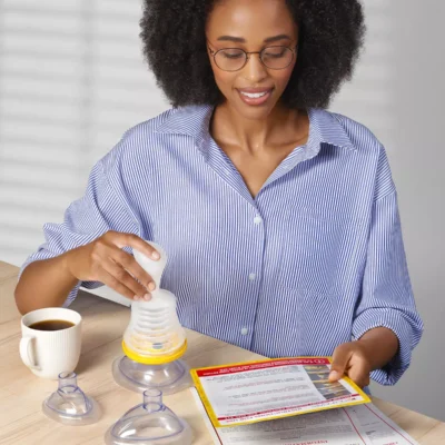Woman assembling suction device and reading instructions.