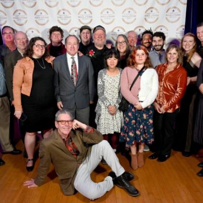 A group of people posing for a picture on a stage.