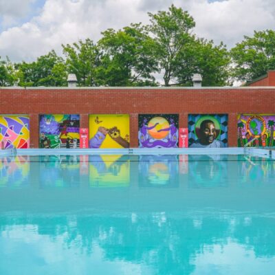 A swimming pool with colorful murals on it.