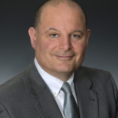 Professional portrait of a man in a suit and tie.