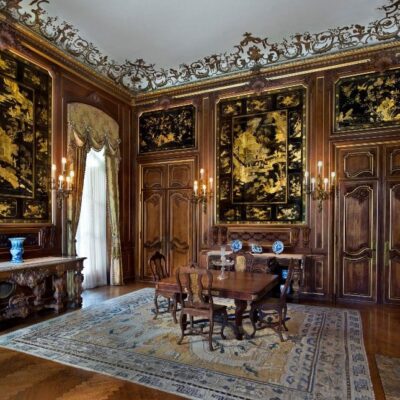 An ornate room with ornate panels and a fireplace.