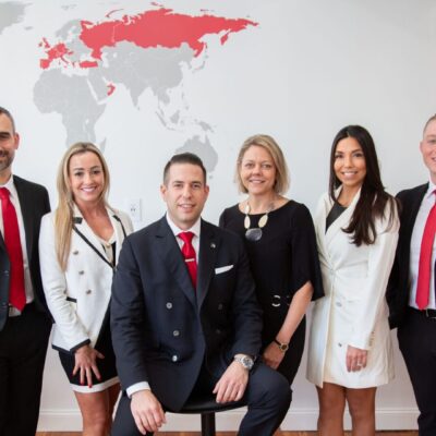 Business team posing in front of world map.