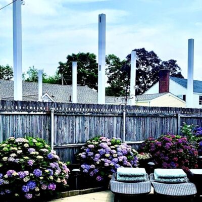 Hydrangeas, patio chairs, fence, and posts.