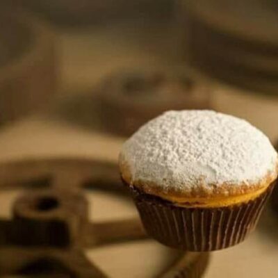 A cupcake with powdered sugar on top of it.