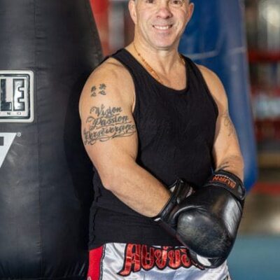 Kevin Kearns posing in front of a boxing bag.