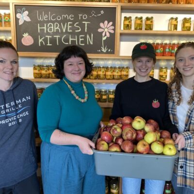 Harvest Kitchen staff with apples.