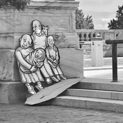 A black and white photo of a group of people sitting on a bench.