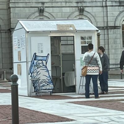 A group of people standing in front of a building.