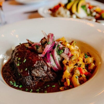 Braised beef with red onions and corn.