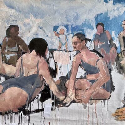 People in swimsuits relaxing outdoors under a cloudy sky.