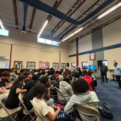 Youth audience listening to speakers.