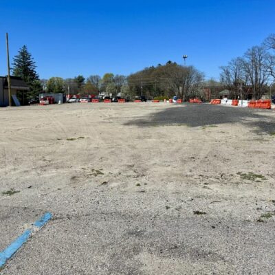 Empty lot with construction barriers.