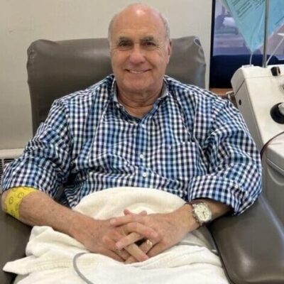 Man sitting in a medical chair, smiling.