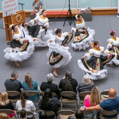 A group of Mexican dancers showcase their exceptional skills in front of an enthusiastic arts audience.
