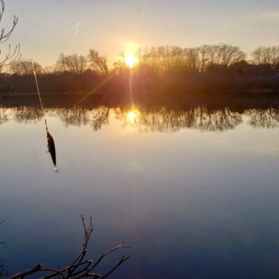 The sun is setting over a body of water.