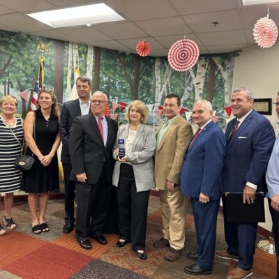 A group of people from Dr. Day Care posing for a picture in a room.