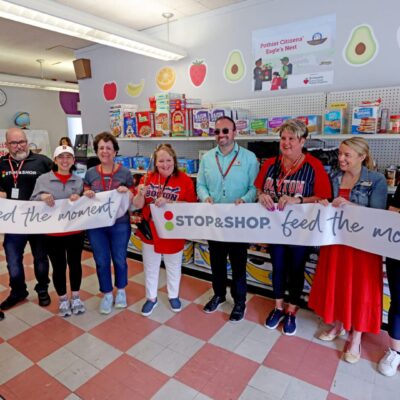 Group holding "Stop & Shop" banner in store.