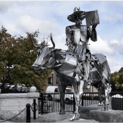 A statue of a man on a cow.