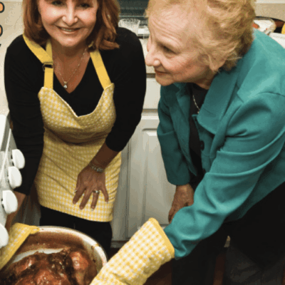 A woman wearing a blue apron.
