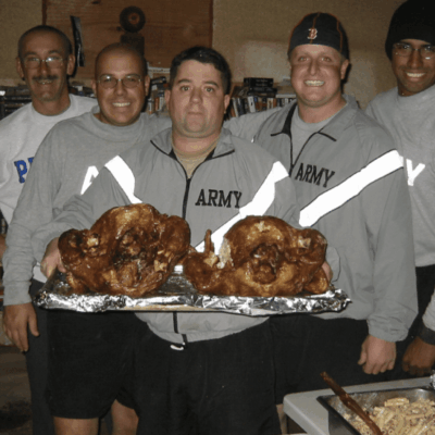A group of men posing with turkeys.