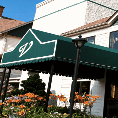 A white building with a green awning.