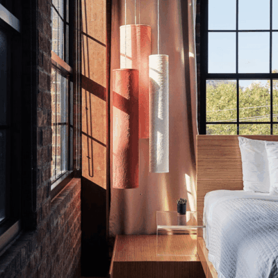 A bed in a room with a window.