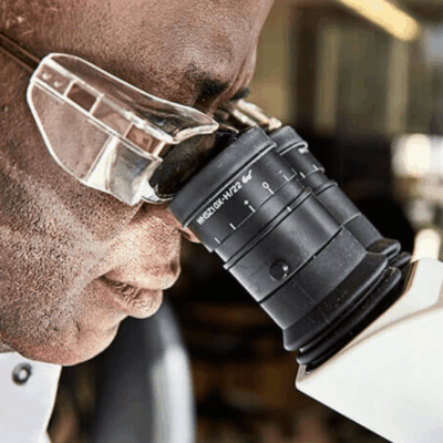 A man looking through a microscope.