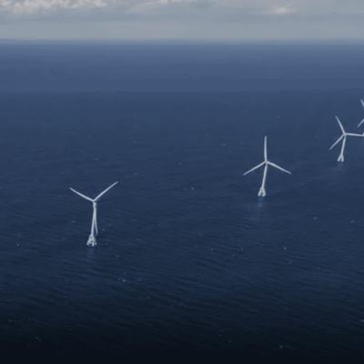 A group of wind turbines in the ocean.