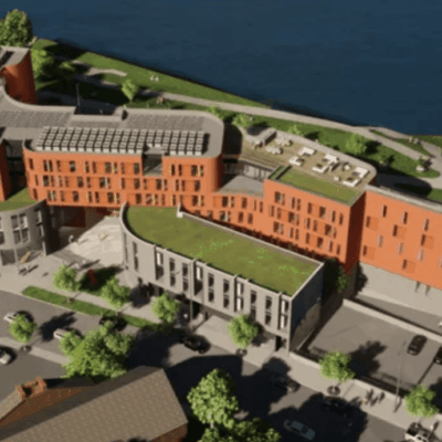 An aerial view of a building next to a river.