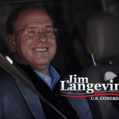 Jim langevin in a car with a smile on his face.