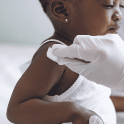 A child is being given a vaccine in a hospital.