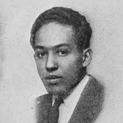 A black and white photo of a man in a suit.