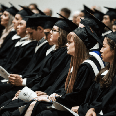 A group of graduates sitting in a row.